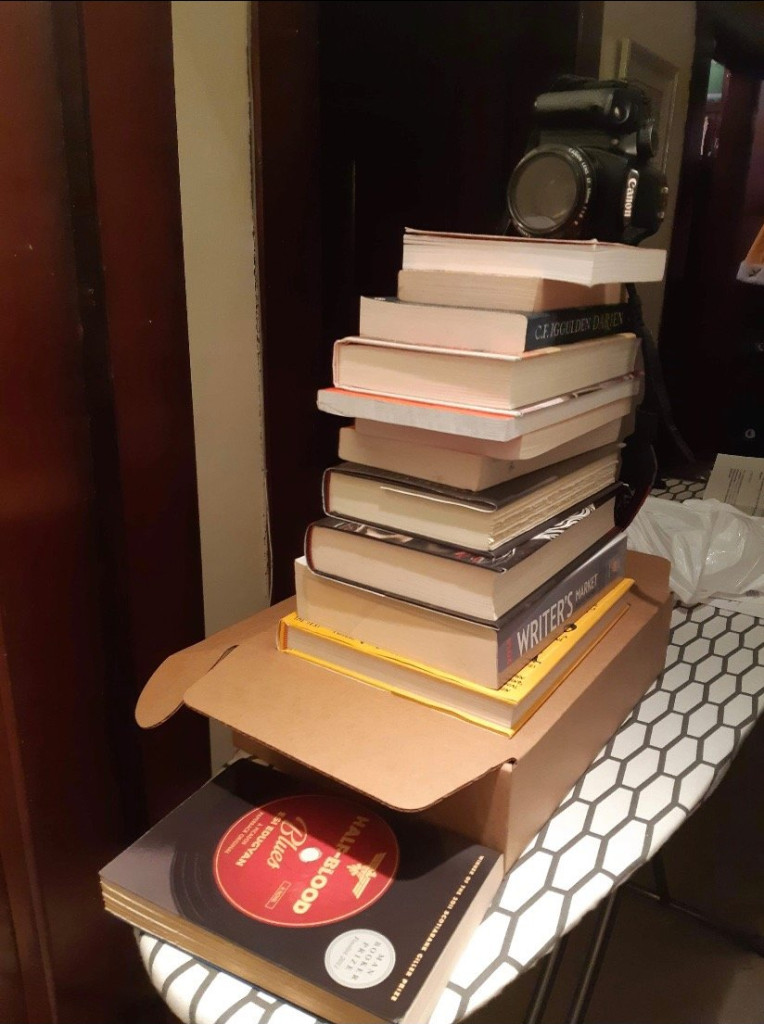 My makeshift camera tripod made up of books and an ironing board. A TRUE beginner YouTuber move.